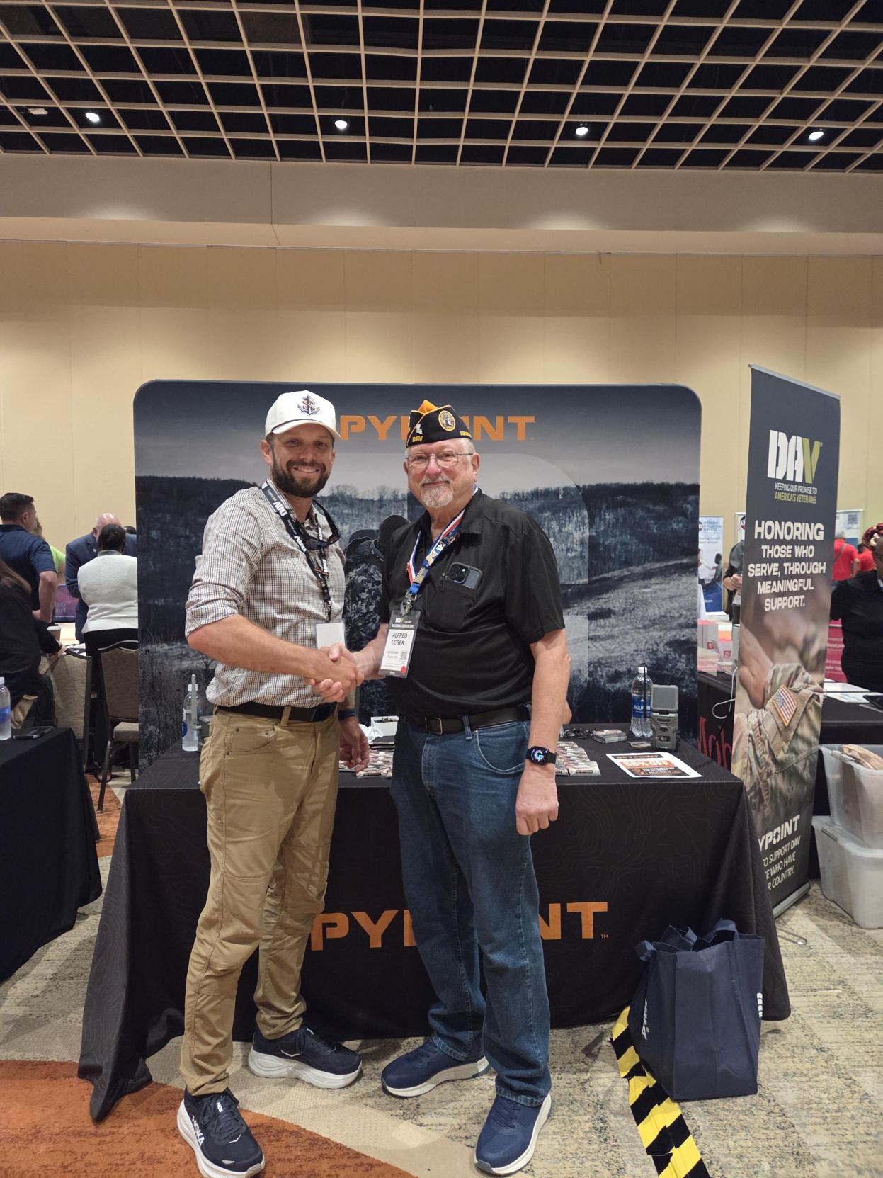 Blog-386_Image-1-SPYPOINT-and-DAV-at-2026-Convention SPYPOINT representative with a DAV member at the SPYPOINT booth during the 2026 DAV National Convention.