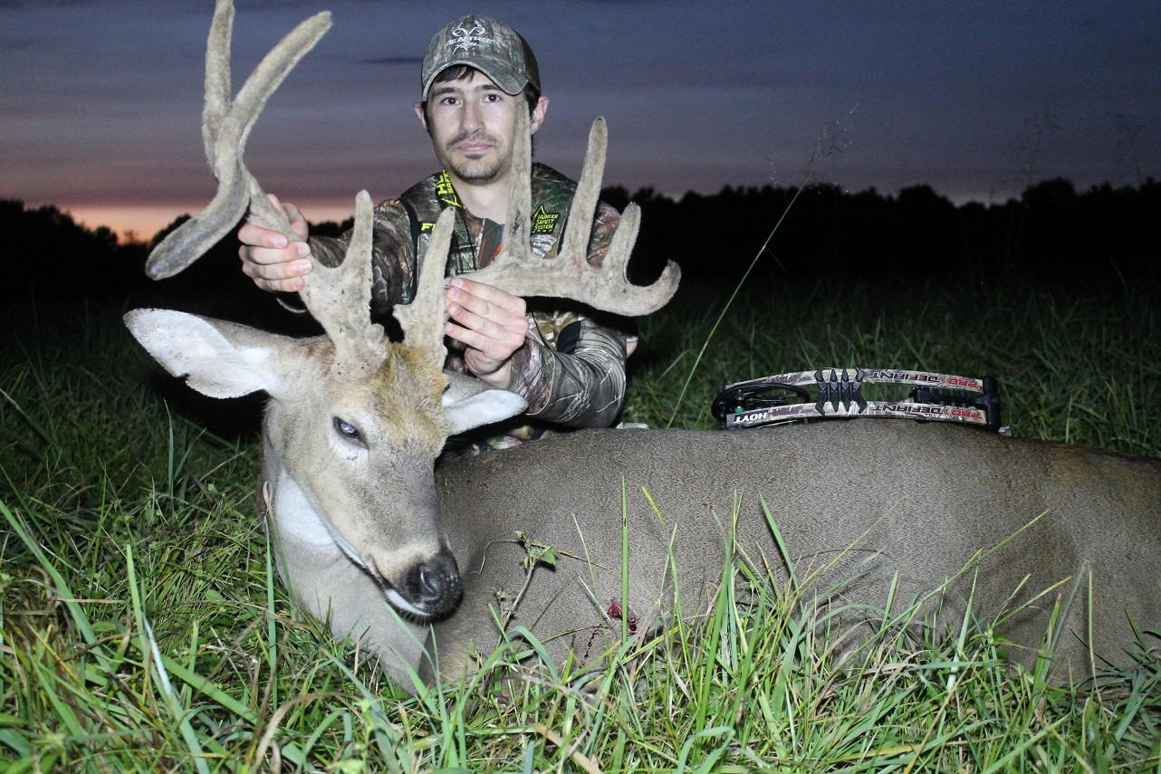 The author admires a nice buck he arrowed on a hot day.  (Josh Honeycutt photo)